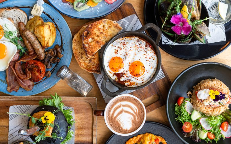 Table top view of breakfast food displayed on table.
