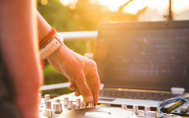 Dj mixing music outdoor. DJ's hands mix the sound on the control panel